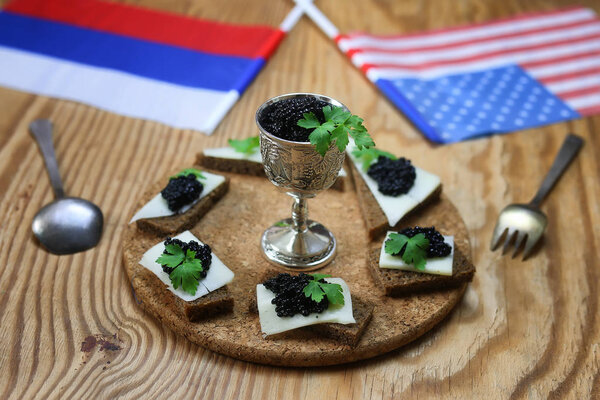 snack black caviar on wooden background