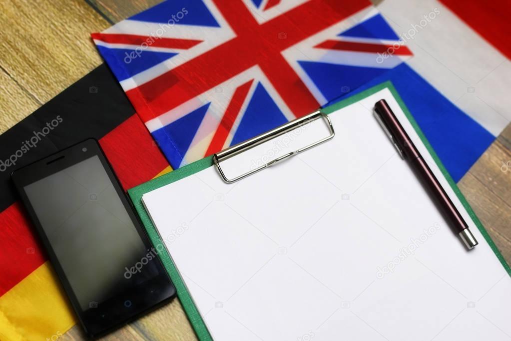 blank paper on wooden textural desk with mobile phone