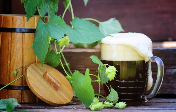 Dark beer with wooden barrel — Stock Photo, Image