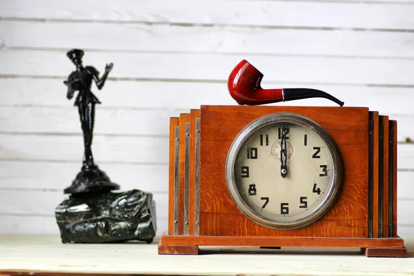 Old clock and smoking pipe — Stock Photo, Image