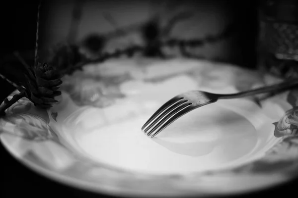 Tenedor en plato negro blanco —  Fotos de Stock