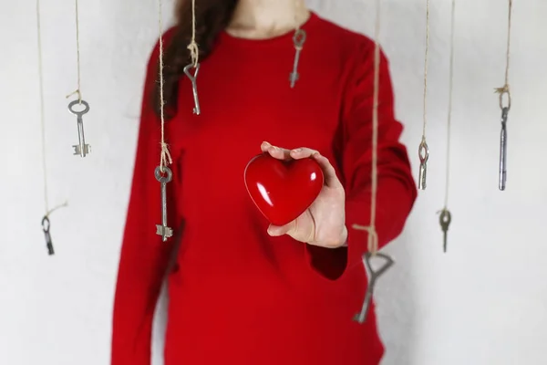 Frau streckt seine Hand in Form eines roten Herzens aus — Stockfoto
