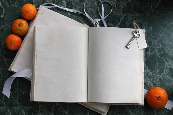 pages opened vintage book on green marble countertop