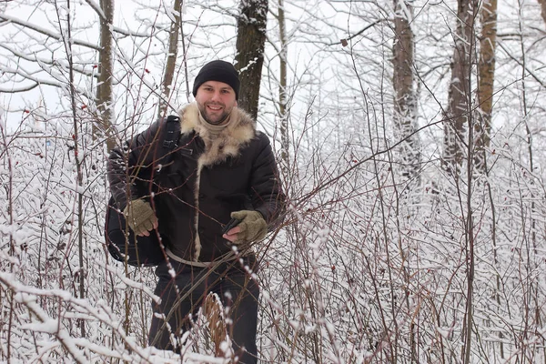 bearded man walking in a winter park