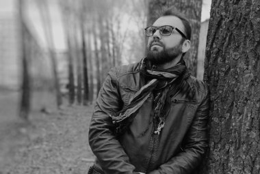 Kulaklıklı, parktaki sakallı adam.