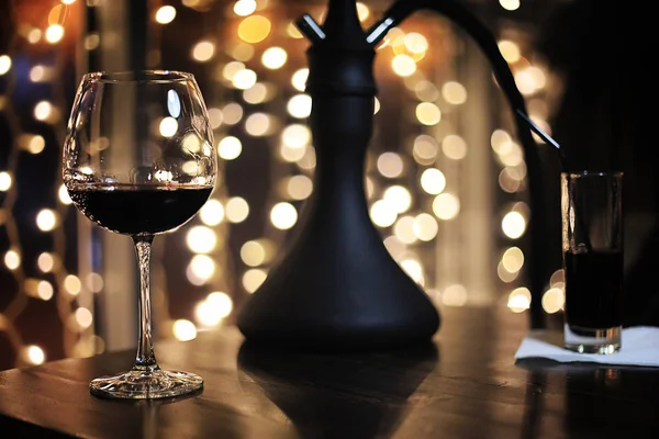 Glass of alcohol with ice on blured background with circle bokeh — Stock Photo, Image