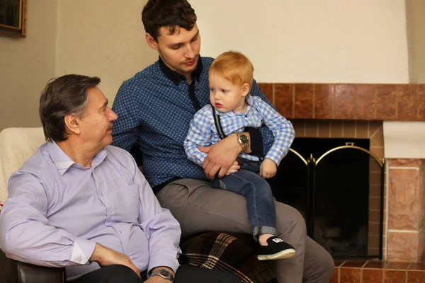 Family day at the fireplace in a country house