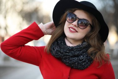 Şehirde kırmızı paltolu bir yolda güzel kız