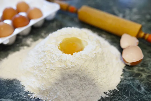 different ingredients for preparing flour products on kitchen ta