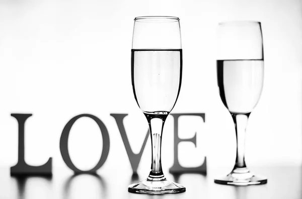 Fotografie monocrom de șampanie pe masă albă pe fundal alb — Fotografie, imagine de stoc