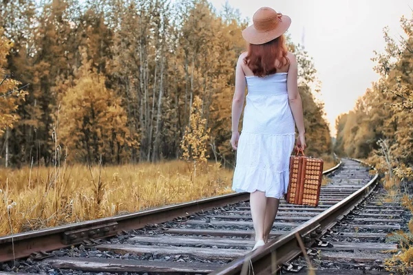 Autunno parco ragazza in sundress bianco e una valigia di vimini a piedi — Foto Stock