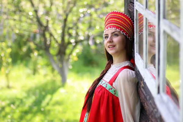 Escravo mulher no vestido tradicional parede de madeira — Fotografia de Stock