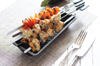 Pişmiş sebze ile metal şiş üzerinde kebap