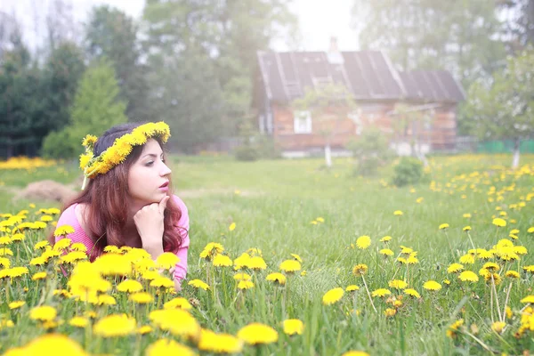 Sarı dandelions çayırda güneşli bir dinlenme kız