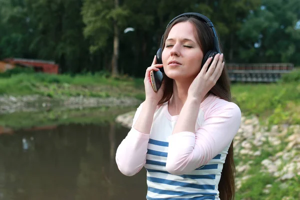 Mädchen hört Musik im Freien über Kopfhörer lizenzfreie Stockbilder