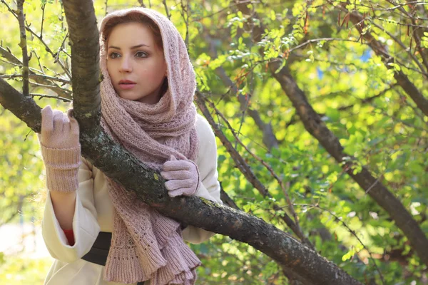 Girl in a park wearing a scarf — Stock Photo, Image