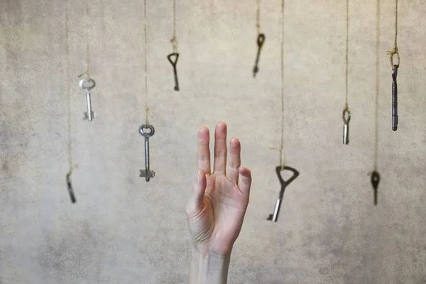 Hand stretching for one of the many old vintage keys — Stock Photo, Image