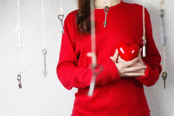woman stretches out his hand with a shape of red heart