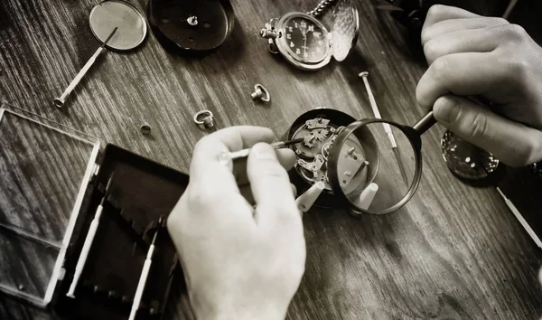 black and white photo watch clock repairing