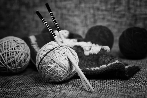 embroidery wool balls and knitting needles