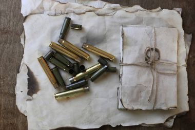 bullet and retro paper on the table clipart