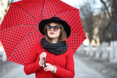 Güzel kız şehirde bir şemsiye ile bir yolda