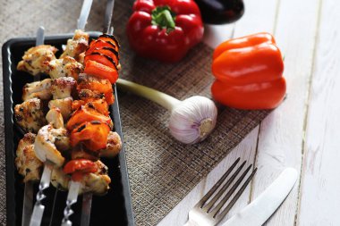 Pişmiş sebze ile metal şiş üzerinde kebap