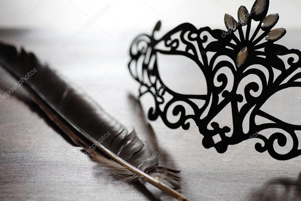 Black mask on the wooden background