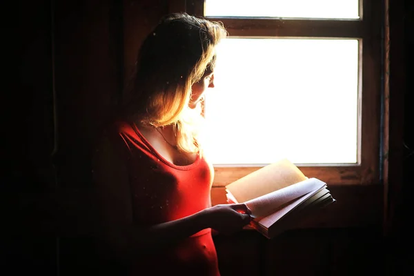 Silhouette of a beautiful girl in a red dress — Stock Photo, Image