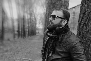 Kulaklıklı, parktaki sakallı adam.