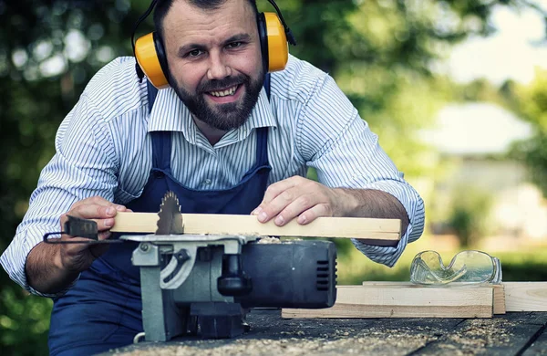 Werknemer baard man met cirkelzaag — Stockfoto