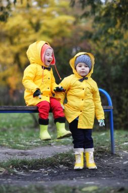Children in the autumn park walk clipart