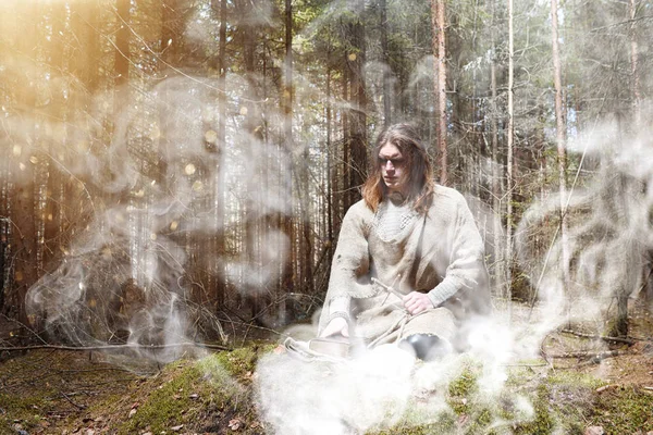 Ένας άνθρωπος με ράσο ξοδεύει ένα τελετουργικό σε ένα σκοτεινό δάσος — Φωτογραφία Αρχείου