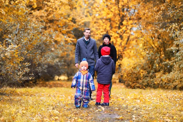 Family in autumn park in the afternoon — Stock Photo, Image