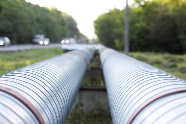 As pipeline from metal pipes on the street. Gas supply through pipes. — Stock Photo, Image