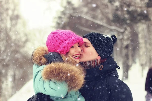 Jovem casal homem carrega uma menina inverno — Fotografia de Stock
