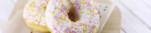 Horizontal bakground of donuts on a wooden — Stock Photo, Image