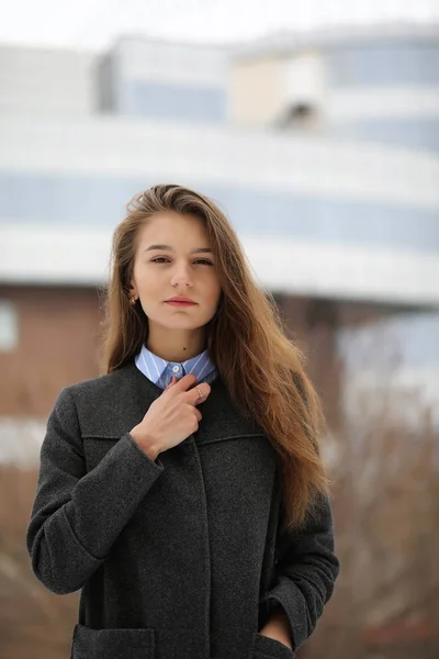 Giovane ragazza adulta in cappotto sulla strada — Foto Stock