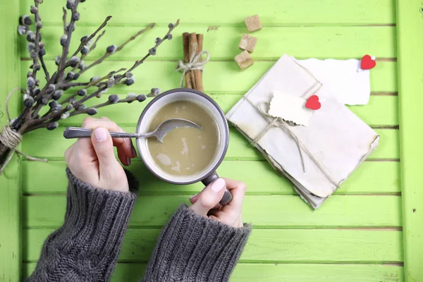 Girl drinking hot coffee and looks presented valentines — Stock Photo, Image