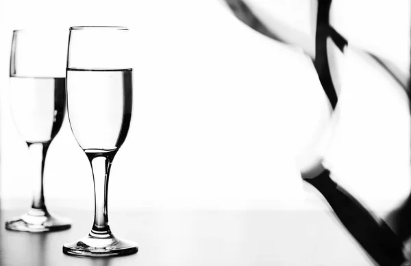 Monochrome photo of champagne on white table on white background — Stock Photo, Image