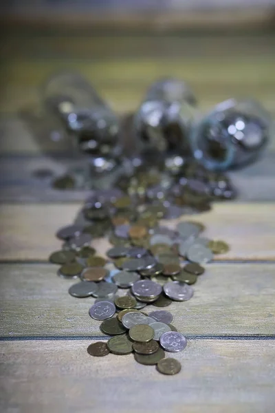 Accumulated coins stacked in glass jars — Stock Photo, Image