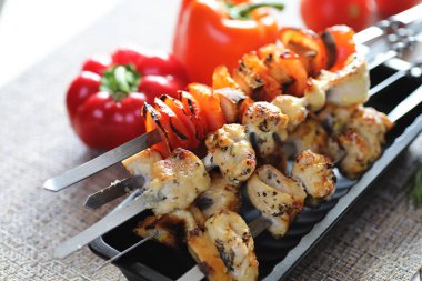 Pişmiş sebze ile metal şiş üzerinde kebap