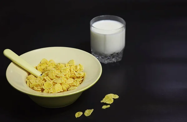 Corn flakes in a plate. Breakfast from flakes with honey and mil