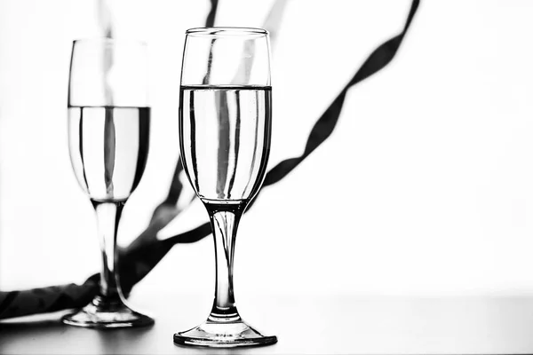 Monochrome photo of champagne on white table on white background — Stock Photo, Image