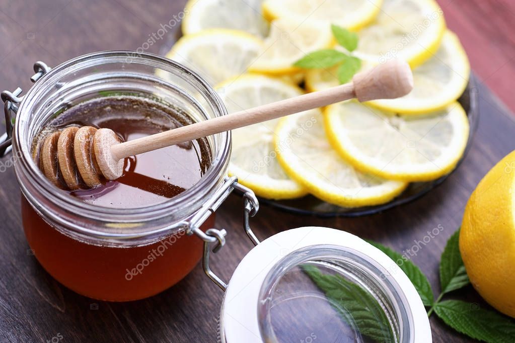 Fresh honey with a cup of black tea