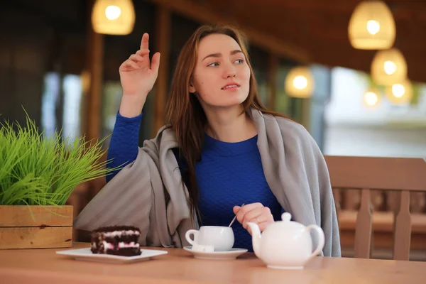 Ung flicka i café sitter och dricker te — Stockfoto