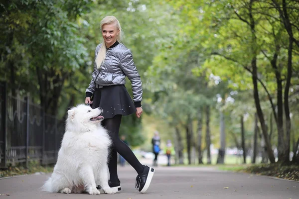 Lovely girl on a walk with a beautiful dog — Stock Photo, Image