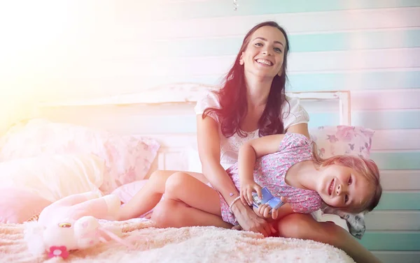 Young girl reads a book Young girl with a daughter are sitting o