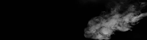 White smoke on a black background. Texture of smoke. Clubs of white smoke on a dark background for overlay