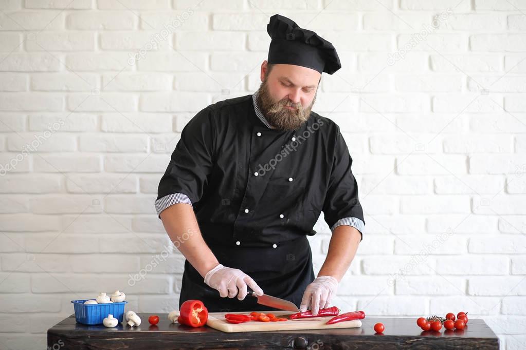 Bearded chef chef prepares meals